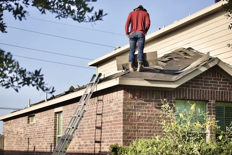 Professional roofer working on a residential roof in Amtrak